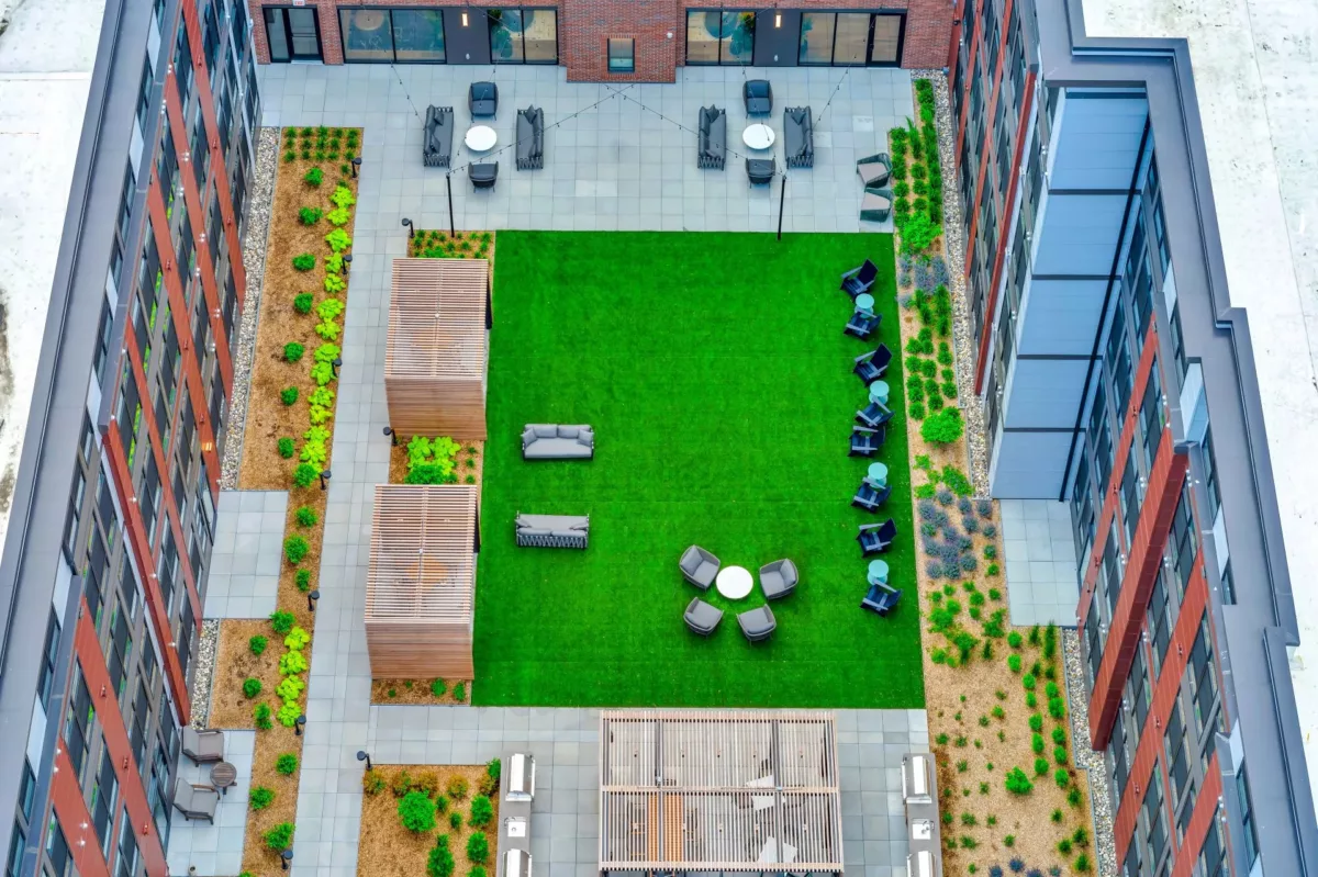 Overhead view of courtyard lawn, shaded seating, and pathways.