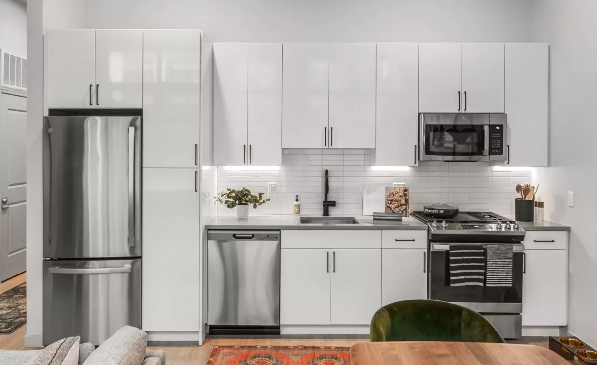 Modern kitchen with white cabinetry, stainless steel appliances, and subway tile backsplash.
